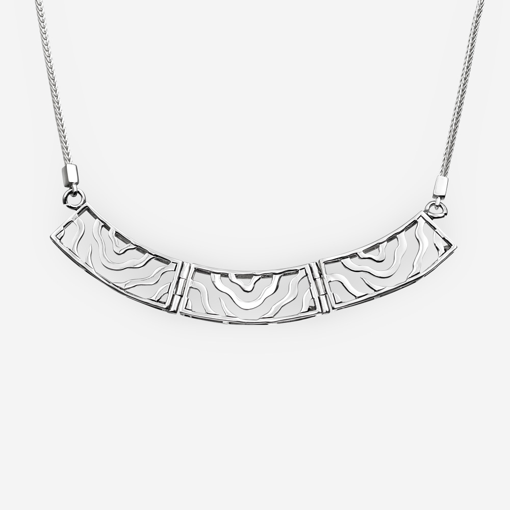 Collar de plata moderno con enlaces de diseño de onda abstracta recortada que cuelgan de una cadena retorcida.