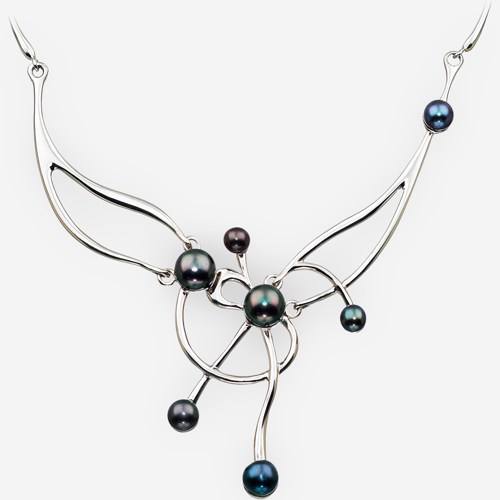 Sterling silver asymmetrical pearl necklace featuring black freshwater pearls and a high polished finish.
